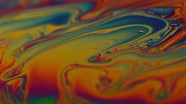 macro video of a colorful soap bubble surface with smooth flowing liquid waves and rich organic textures. Abstract natural motion background for web design, presentations, science visuals, creative