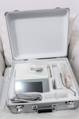 Dental equipment set in hard case with device, cables and handpieces for mobile professional dental practice.