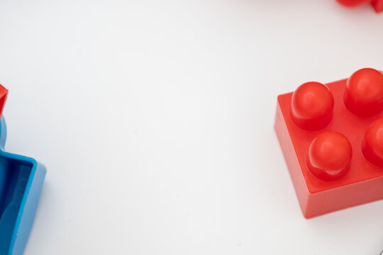 Colorful plastic building blocks on white background