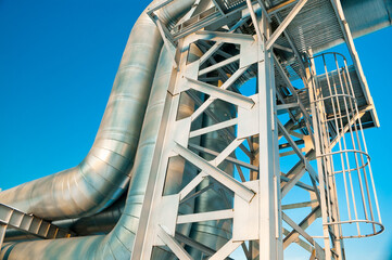 Fototapeta premium pipeline and metal support against the blue sky