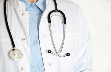 Healthcare professional taking notes in a clinical setting during a routine check-up