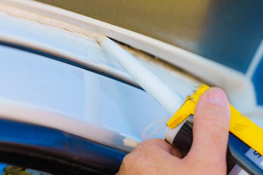 Applying silicon on caravan body