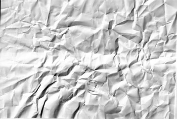 Obraz premium Crumpled white paper sheet texture with dark shadows and folds forming abstract pattern