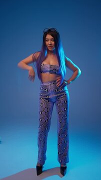 Confident woman in cropped top and pants. Stylish glamour concept.