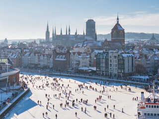 Hundreds of people walk along the frozen Motława River in Gdańsk during a frosty winter. Poland