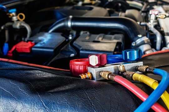 A/C Manifold Gauges Set. Check pressure and leak for use air conditioning systems. Recharging car air conditioner with refrigerant using grade gear with separate gauges to monitor pressure in system.