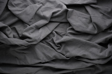 Gray Fabric Showing Folds and Creases in a Close-Up View on a Surface