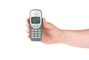 Hand holding old push-button mobile phone on isolated white background.