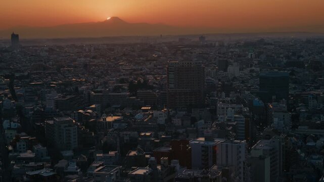 Aerial view of Tokyo at sunset from the Mount Fuji side, showing the city skyline under warm evening light.

Tokyo city seen from a