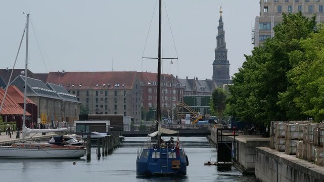 Copenhagen, Zealand and Amager, Denmark - February 8, 2026: Canal View in Copenhagen Denmark with Sailing Yachts and Church Spire