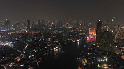 Fototapeta premium Skyscrapers in Bangkok city and river at night