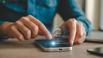 Person using smartphone with KYC icon and glowing effect for verification mobile phone