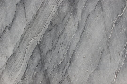 Grigio Billiemi marble texture with artistic flowing diagonal dark grey and white line patterns.