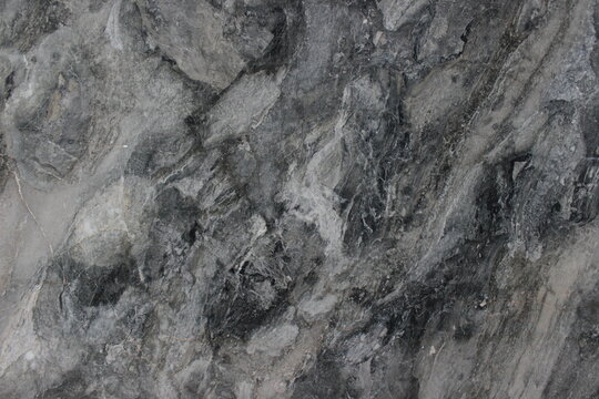 Grigio Carnico marble texture from Italy with a dramatic natural blend of dark gray tones and white patches.
