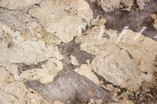 Exotic Patagonia quartzite texture with a blend of transparent crystal fragments, beige, and large unique brown veins.