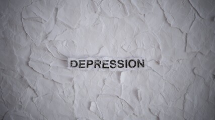 Crumpled piece of paper with word Depression on torn crumpled white paper pieces background