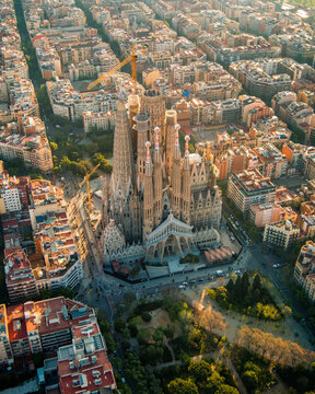 Aerial view of Barcelona featuring the Sagrada Fam&iacute;lia rising above the geometric Eixample district. Iconic urban planning and architecture define this Mediterranean cityscape