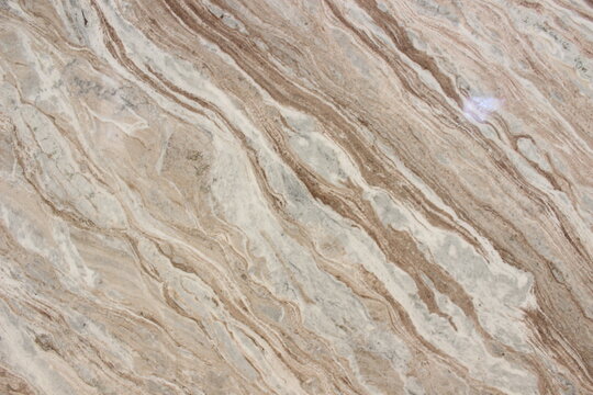Fantastico Brown marble texture with dynamic diagonal vein patterns in brown, cream, and white color combinations.
