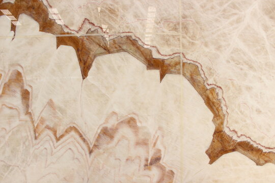 Onyx marble texture with exotic large brown and ivory white crystal fracture patterns.