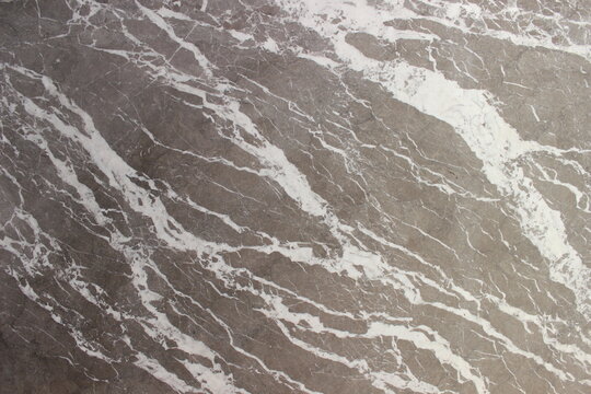 Grigio Billiemi brownish gray marble texture with dense white vein weaving and rich natural stone texture.