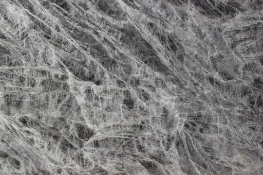 Texture of Grey William marble in grey with interlocking white mineral fibers forming an artistic natural mesh pattern.
