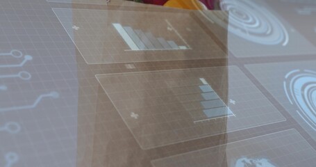 Displaying translucent panels over glass panel in office, showing blue charts and radar