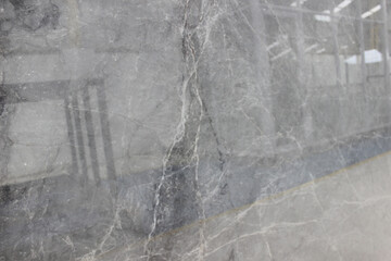 Close up of polished Tundra Grey grey marble, showing natural vein details for an aesthetic background.