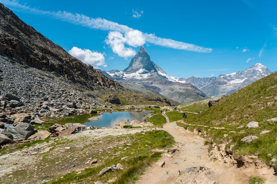 Sunny summer view of Riffelsee Lake with Matterhorn reflection, Swiss Alps