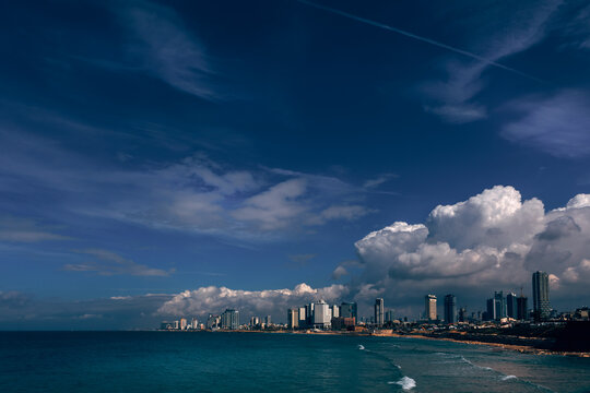 View into land of a cityscape with skyscrapers along the beach, Tel Aviv, Israel
