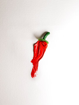 Overhead view of a conceptual red chilli pepper made from acrylic paint