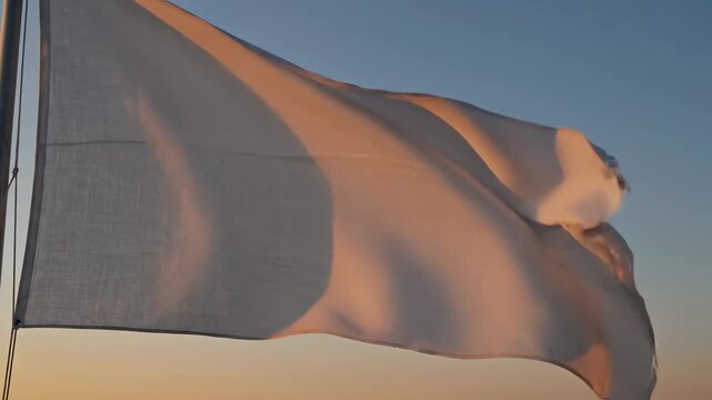 White flag waving in wind at sunset 4K Video
