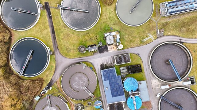 Aerial View of Modern Wastewater Treatment Plant with Circular Clarifiers	
