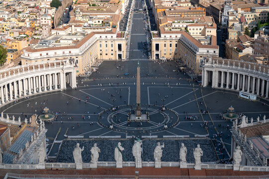High-Angle Panoramic View of St. Peter's Square and Rome Cityscape Description: A breathtaking aerial perspective taken from the top of Michelangelo's dome (Cupola). The image showcases the symmetrica