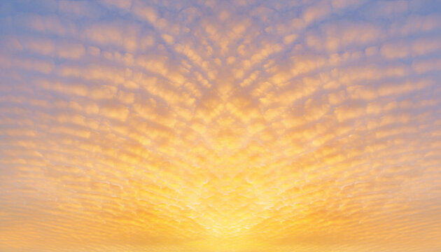 A majestic pattern of rippled clouds catching vibrant golden light. This symmetrical natural texture creates a high-end, peaceful background with copy space for luxury branding.