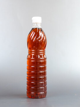 Thai fish sauce in a plastic bottle on table wood white background.
Dipping Nam Pla traditional thai restaurant.
top view