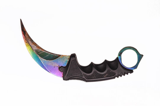 Rainbow Iridescent Karambit Knife with Black Handle. A studio shot of a curved karambit knife featuring a vibrant rainbow-gradient blade. 