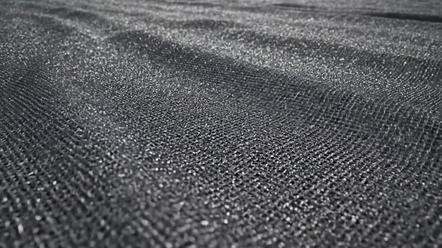 Close view of dark woven fabric texture, detailed textile pattern for fashion and upholstery design, minimal background with calm monochrome mood for branding