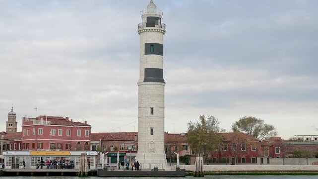 Ferry Dock and Murano Lighthouse Seen from Boat in Venice Lagoon