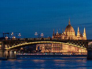 Fototapeta premium Illuminated Hungarian Parliament Building and Danube river at the night. Budapest capital od Hungary.