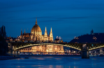 Fototapeta premium Illuminated Hungarian Parliament Building and Danube river at the night. Budapest capital od Hungary.