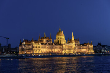 Fototapeta premium Illuminated Hungarian Parliament Building and Danube river at the night. Budapest capital od Hungary.