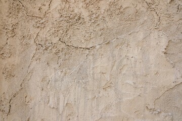 Naklejka premium Authentic sandstone wall texture with aged surface and handmade plaster. Warm neutral background for modern design, interfaces, websites and luxury branding projects.