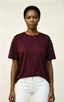 Woman wearing maroon t-shirt and white jeans studio portrait