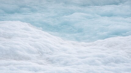 Obraz premium White frothy water waves mixing with light blue water in a natural setting, showcasing the dynamic textures and patterns of aquatic movement