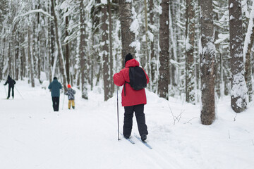 Cross-country skiing in hilly terrain in winter. Outdoor fitness.