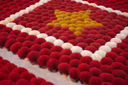 Aerial view of a vibrant display of red, white, and yellow spherical objects creating the national flag, Ung Hoa, Ha Noi, Vietnam.