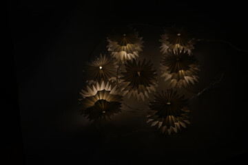 Fototapeta premium Light garland on a black background. Evening lights.