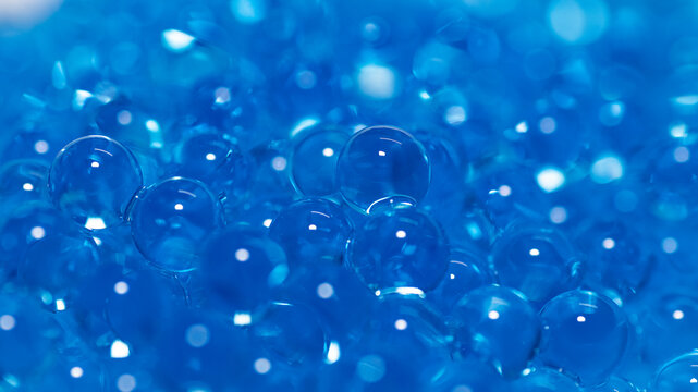 Macro shot of transparent blue hydrogel spheres