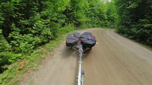 Kayaks on boat trailer with kayaks covered with waterproof dustproof UV protection fabric, transported by truck or car. Water sport fishing. Going to boat launch at lake. Boat trailer fishing kayaks.