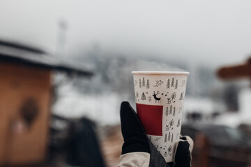 Man is holding a cup of Tea in the frost